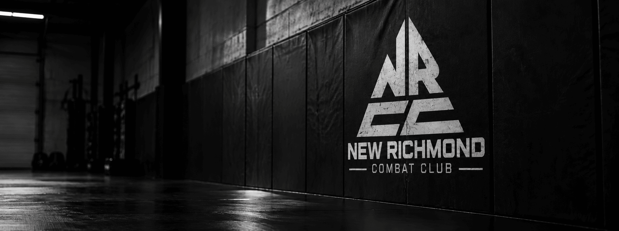 New Richmond Combat Club triangular mark on the academy wall pads
